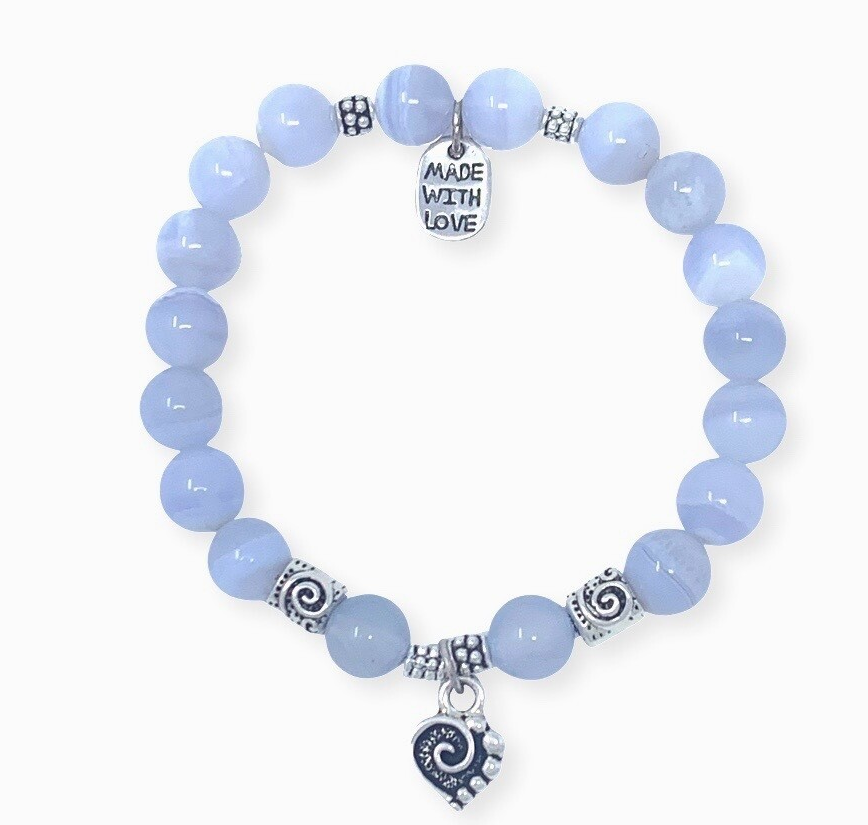 This design features blue chalcedony beads, a heart pendant and silver accent spacer beads that make this sparkle. The heart charm features a spiral center and dots to represent the mind, body & spirit. A reminder to be in love with all three aspects of your Self.