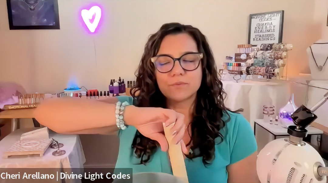 Woman meditating with a singing bowl in a healing studio, surrounded by crystals and candles.