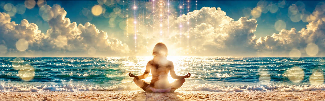Woman meditating on a golden ocean beach with blue and gold light codes.