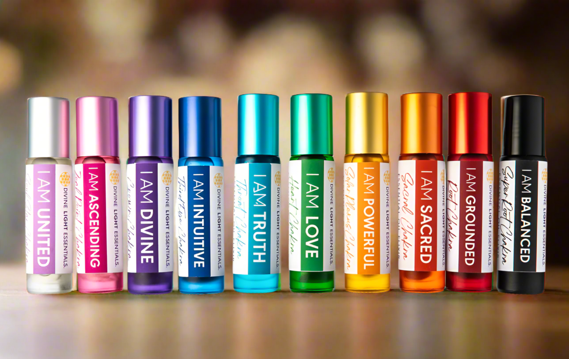 Colorful chakra essential oil roller bottles labeled for energy healing and balance