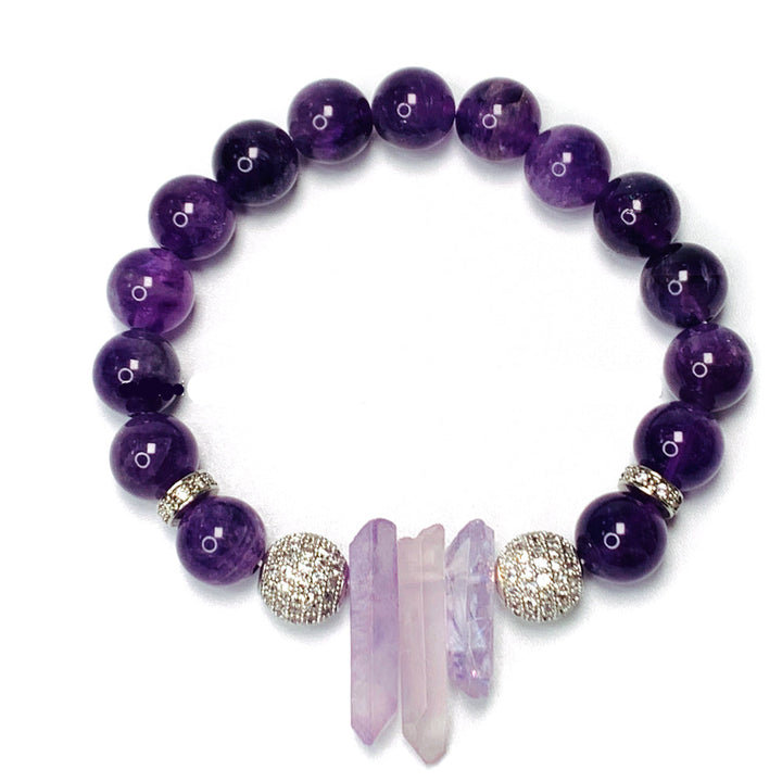 A purple beaded bracelet with clear quartz and amethyst crystals, featuring a mix of 8 and 10 mm beads, and a rhinestone embellishment.