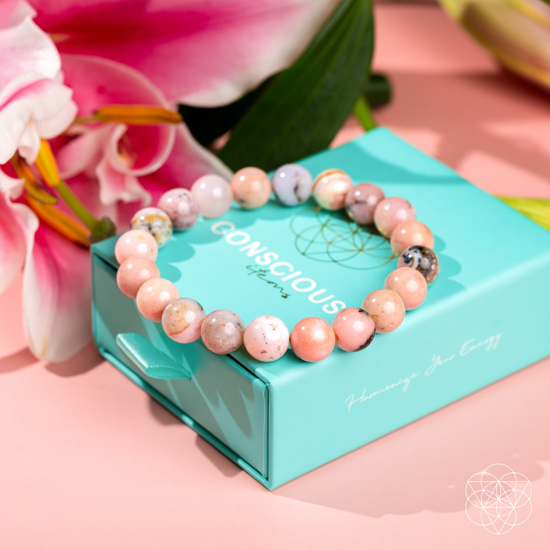 Beaded bracelet on a teal box with pink flowers in the background