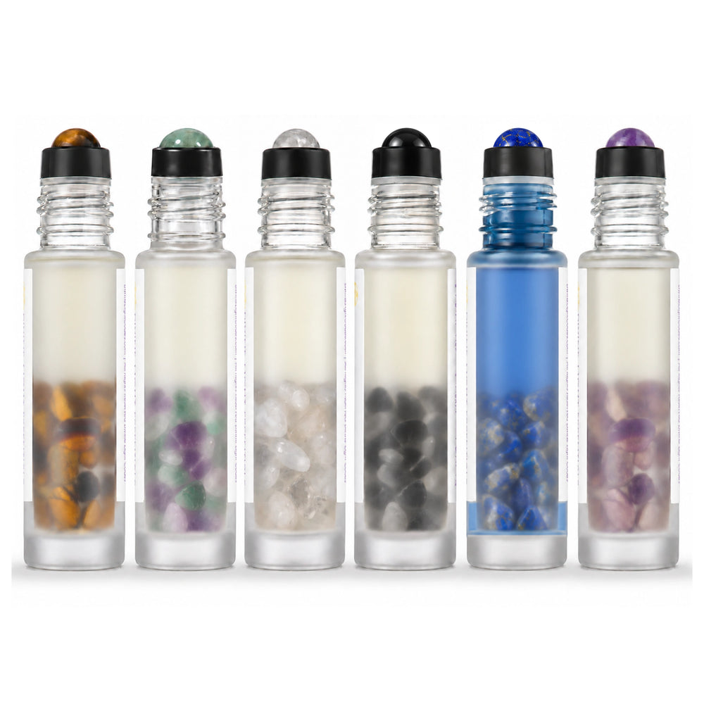 Rear view of six uncapped Emotional Support elixir rollers, showing their crystal rollerballs and stones, on white.