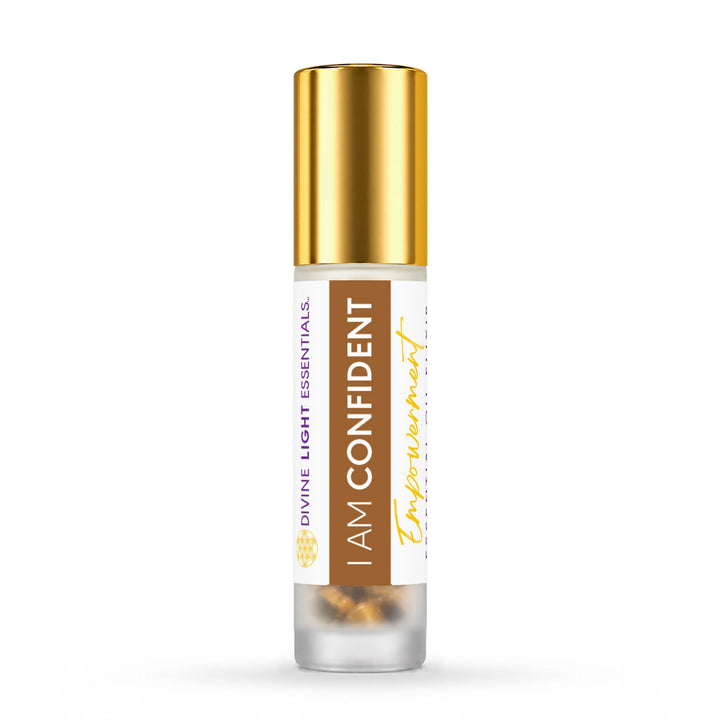 Gold-capped I Am Confident essential oil roller bottle on white.