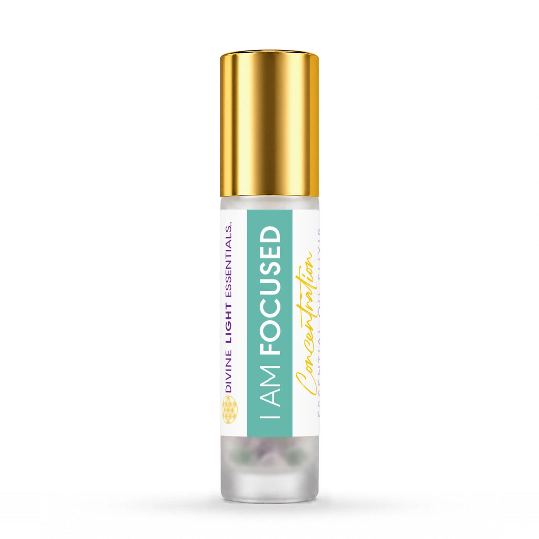 A 10ml glass roller bottle with a shiny gold cap and a white label featuring a mint green vertical stripe. The label reads I AM FOCUSED and Divine Light Essentials.