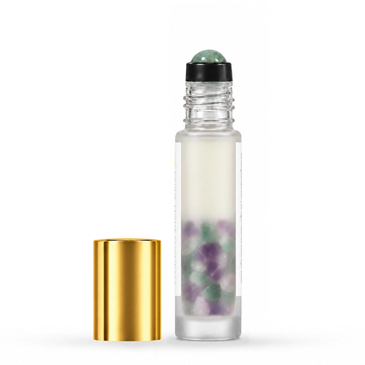 Uncapped rear view of I Am Focused showing rainbow fluorite inside the bottle, with its gold cap beside it.