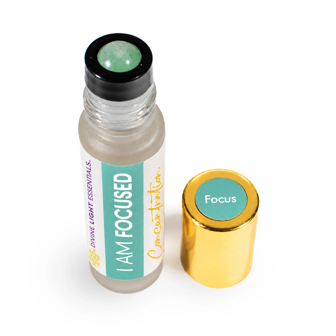 Angled top view of I Am Focused showing its rainbow fluorite rollerball and gold cap.