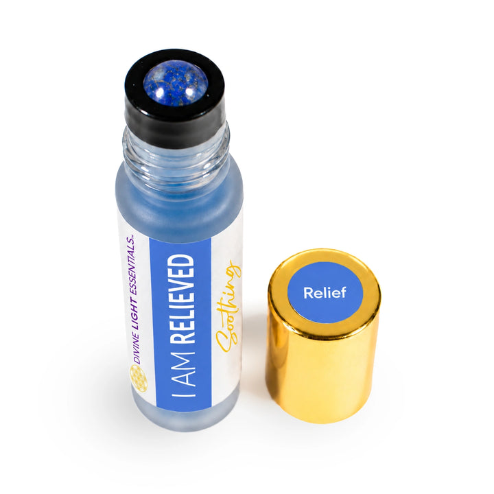 A small glass roll-on bottle with blue liquid and a black roller top, shown next to its gold cap on a white background. The label reads &