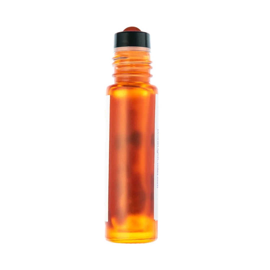Amber glass roller bottle with black cap, containing healing essential oil for spiritual wellness and ascension support.