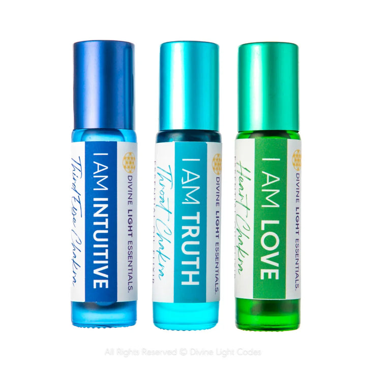Chakra balancing essential oil roller bottles labeled I Am Intuitive, I Am Truth, I Am Love