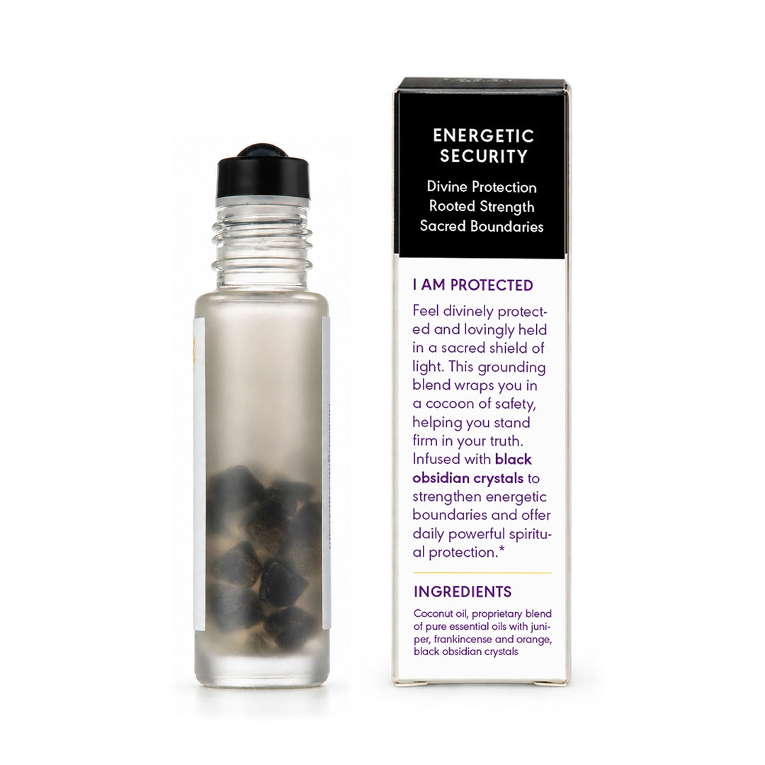 A clear glass bottle with a black cap stands next to its product box. The box is black on top and white on the bottom, featuring the text &