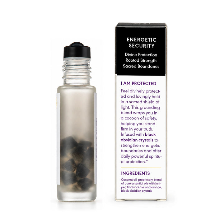A clear glass bottle with a black cap stands next to its product box. The box is black on top and white on the bottom, featuring the text &