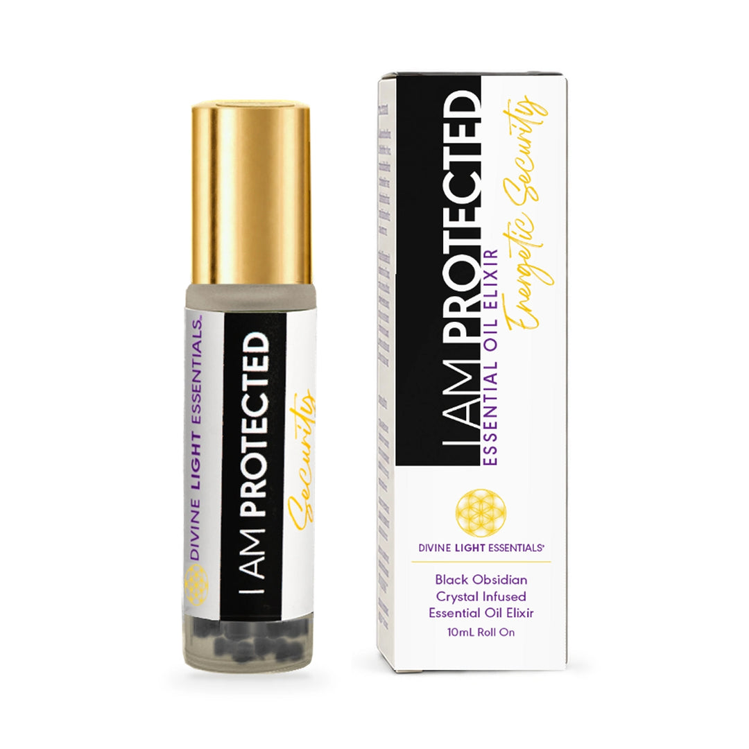 A 10ml roll-on essential oil elixir bottle with a gold cap stands next to its white and black packaging box. The label reads &