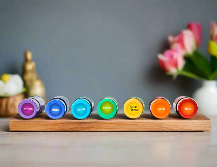 Seven chakra balancing essential oil elixirs in a display