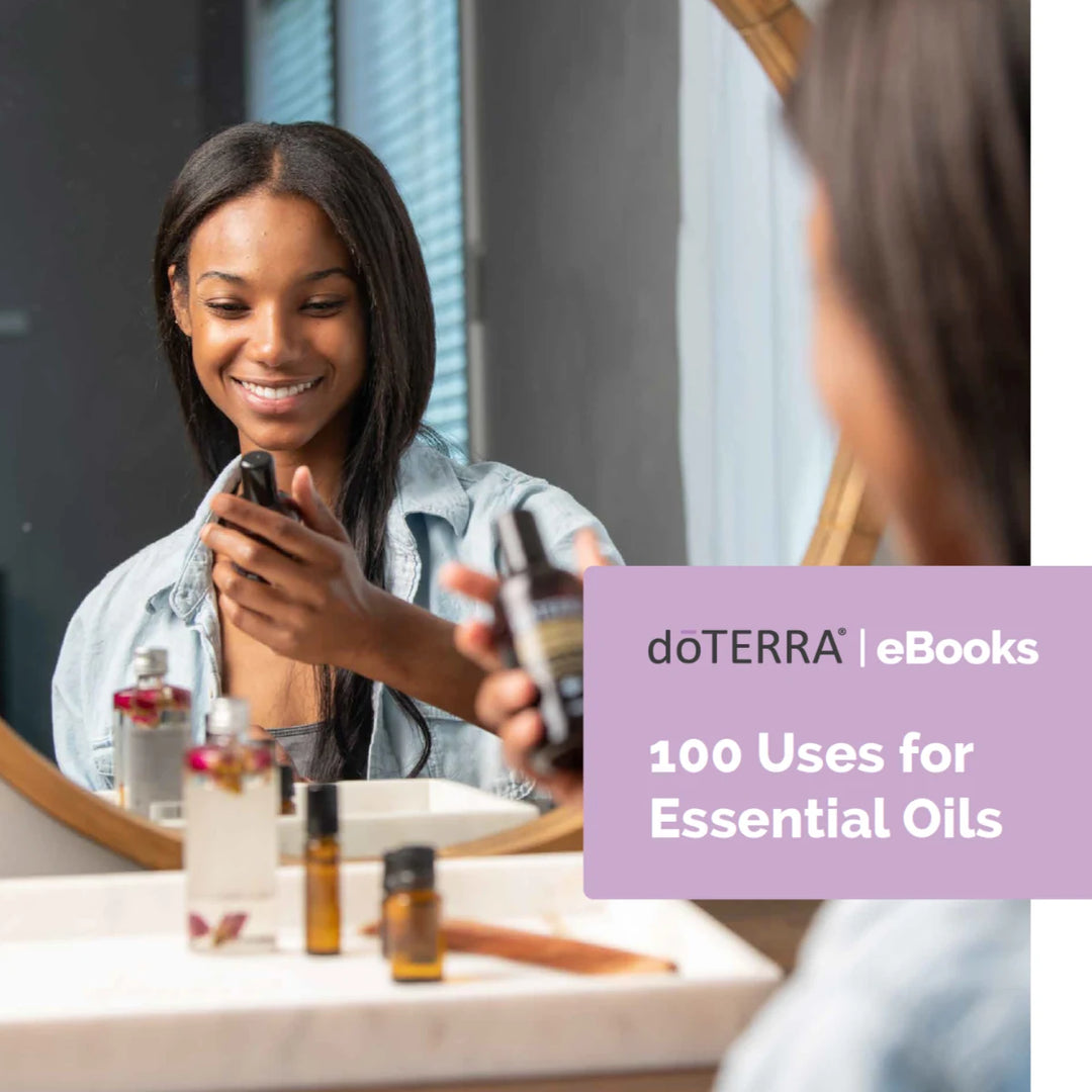 Woman smiling while holding essential oil bottle, mirror reflection, doTERRA eBook promo