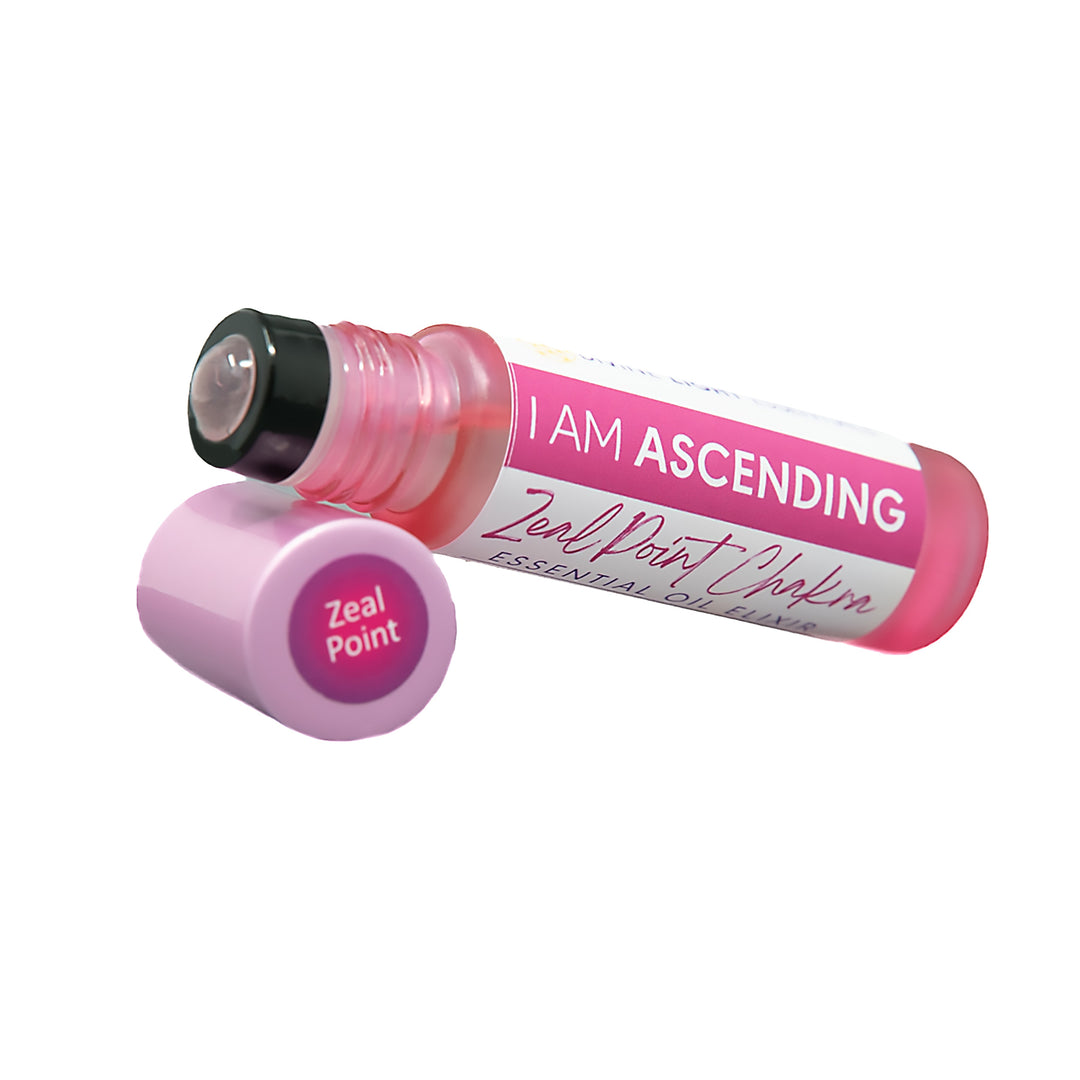 A pink essential oil rollerball bottle labeled &