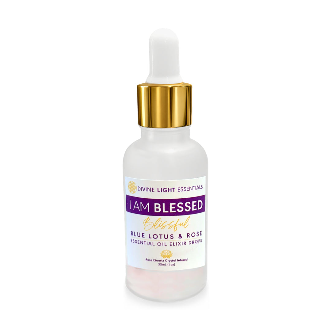 A frosted glass dropper bottle of Divine Light Essentials 'I Am Blessed' Blue Lotus & Rose Essential Oil Elixir Drops, featuring a white dropper cap with a gold collar and a white label with purple and gold text.
