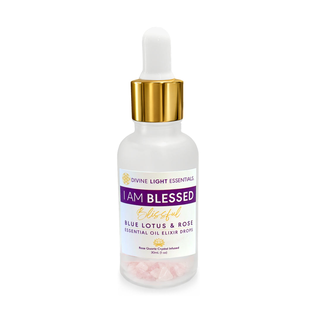 A frosted glass dropper bottle of Divine Light Essentials 'I Am Blessed' Blue Lotus & Rose Essential Oil Elixir Drops, featuring a white dropper cap with a gold collar and a white label with purple and gold text.