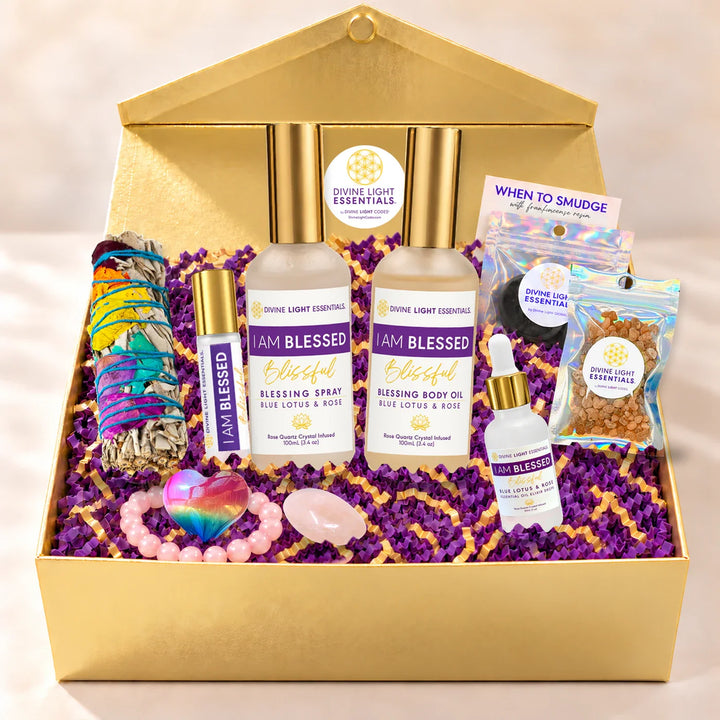 I Am Blessed Wellness Kit in a gold gift box with four elixir bottles, rose quartz bracelet and crystal, rainbow selenite heart, sage, resin and charcoal.