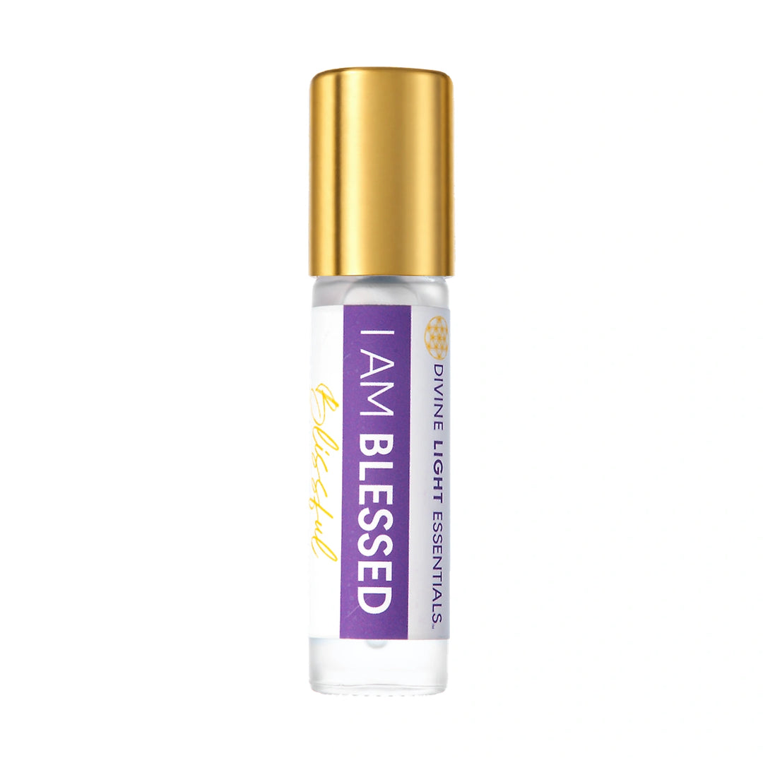 I Am Blessed crystal-infused elixir roller with a soft gold cap, neutral glass and original purple label, centered on white.