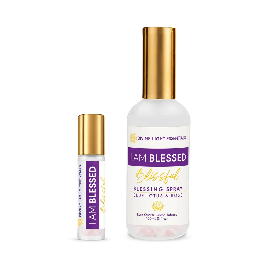 Divine Light Essentials 'I Am Blessed' Blessing Spray set, featuring a 100ml glass bottle with a gold cap and a matching 10ml rollerball bottle, both with purple and gold labels on a white background.