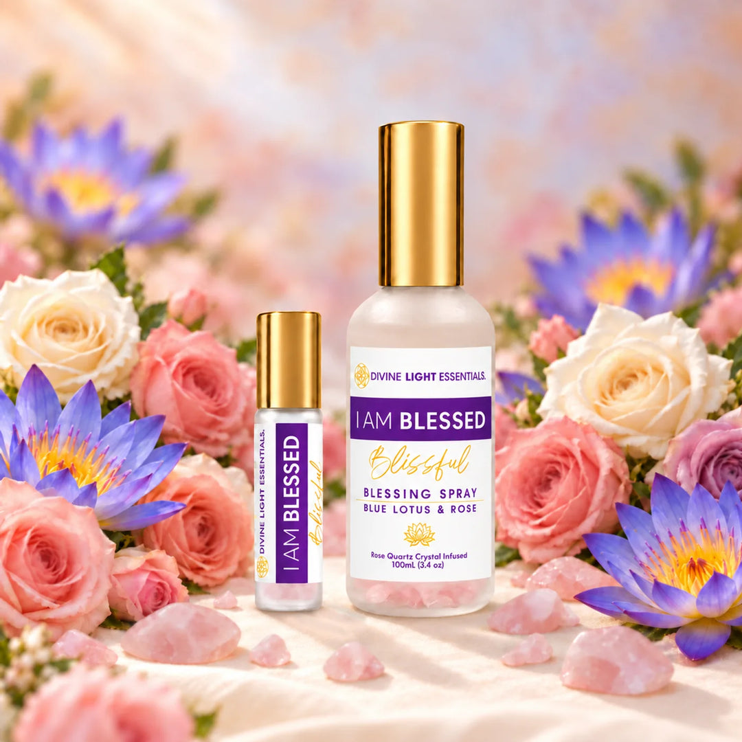 I Am Blessed roller elixir and blessing spray among roses, blue lotus flowers, and rose quartz crystals.