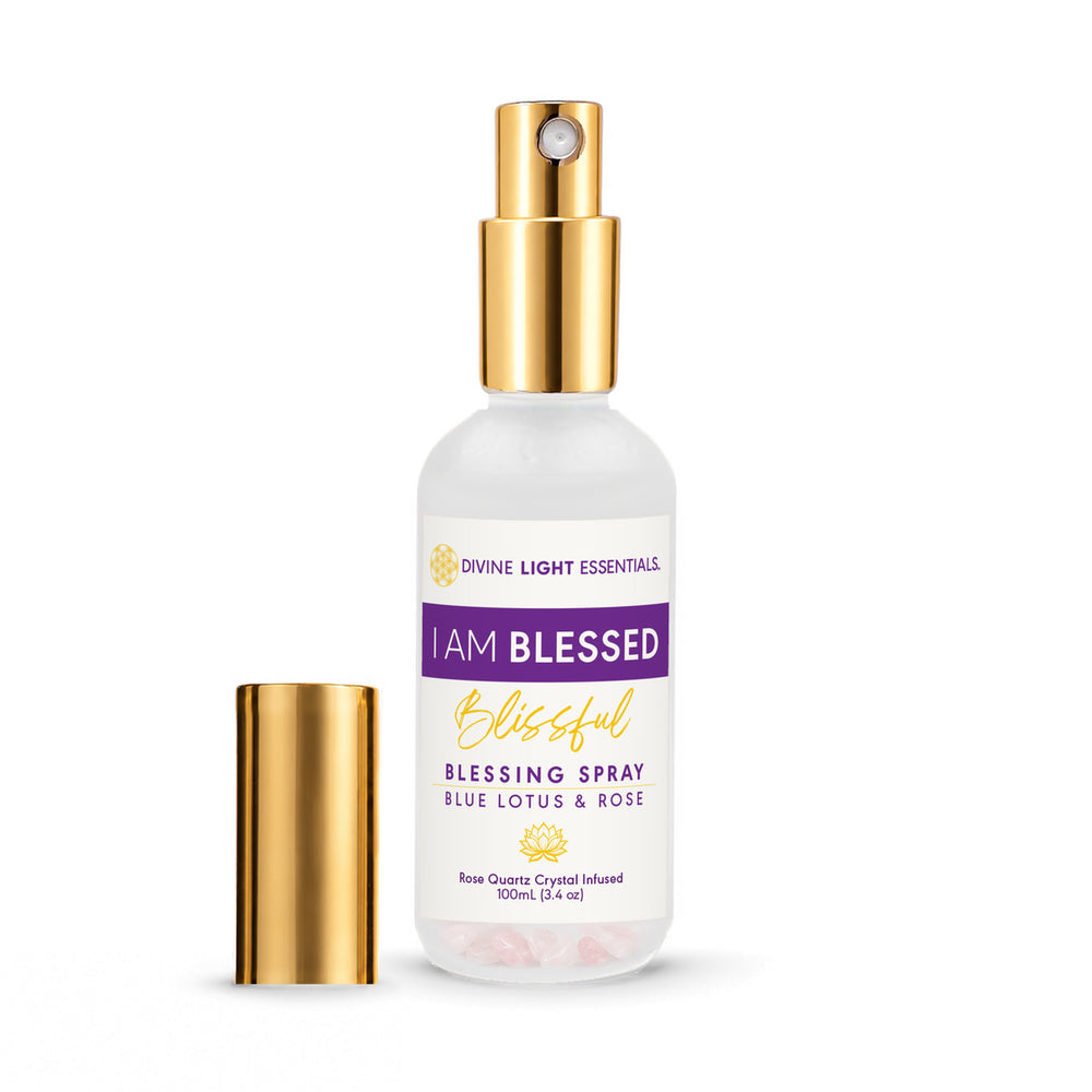 A 100ml bottle of Divine Light Essentials 'I Am Blessed Blissful Blessing Spray' in Blue Lotus & Rose, featuring a frosted white bottle, purple and gold label, and a separate gold cap, shown on a white background.