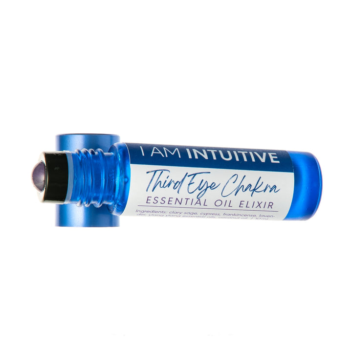 A blue essential oil rollerball bottle labeled &