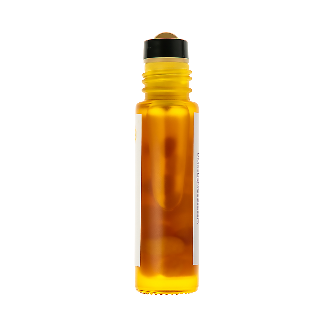 An amber glass roller bottle filled with golden-yellow liquid, featuring a black cap and a blank white label, isolated on a white background.