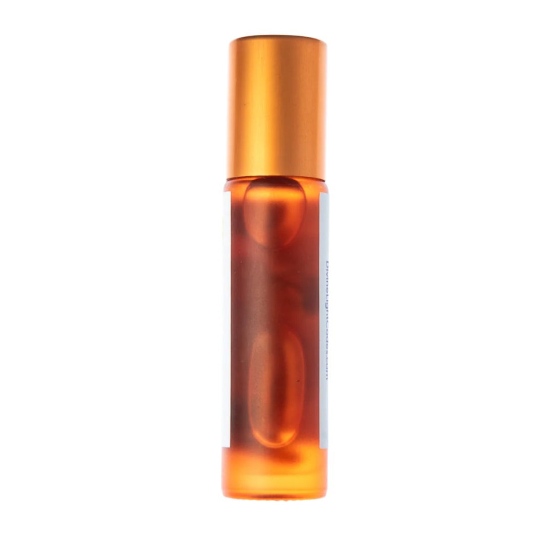 Amber glass roller bottle with gold cap, containing healing essential oil for spiritual wellness and ascension support.