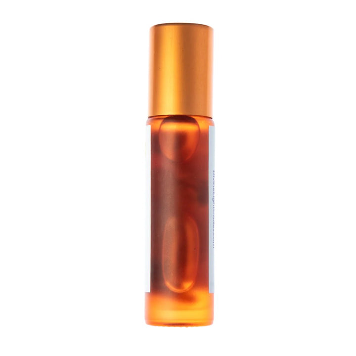 Amber glass roller bottle with gold cap, containing healing essential oil for spiritual wellness and ascension support.