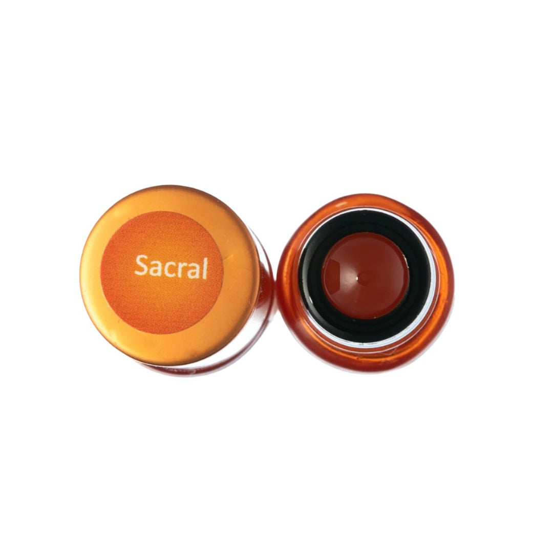 Sacral chakra healing oil in amber glass bottle with orange label, for energy alignment and spiritual wellness