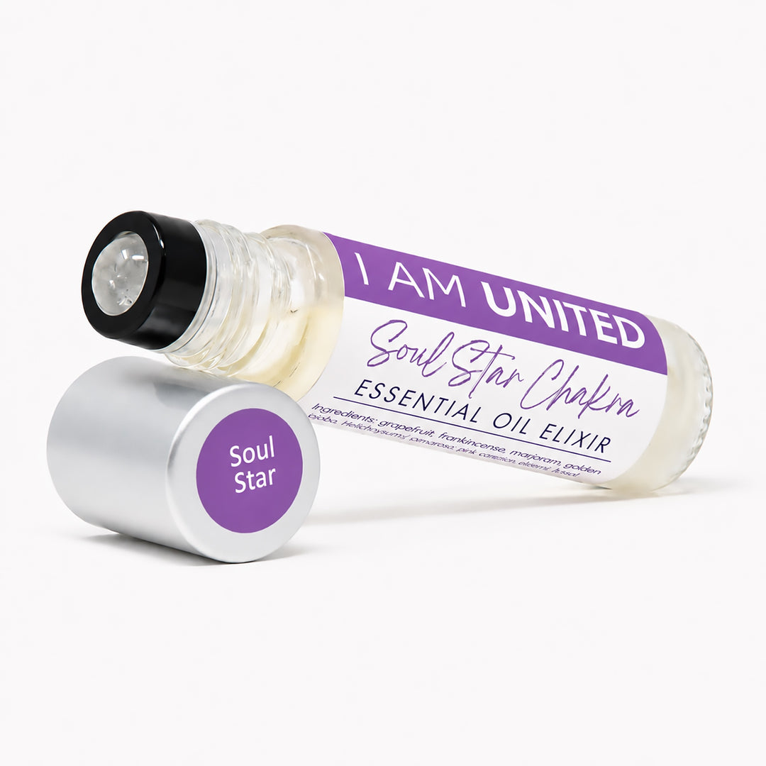 A glass roller bottle of Soul Star Chakra essential oil elixir by I AM UNITED, shown with its silver cap removed and placed beside it on a clean white background.