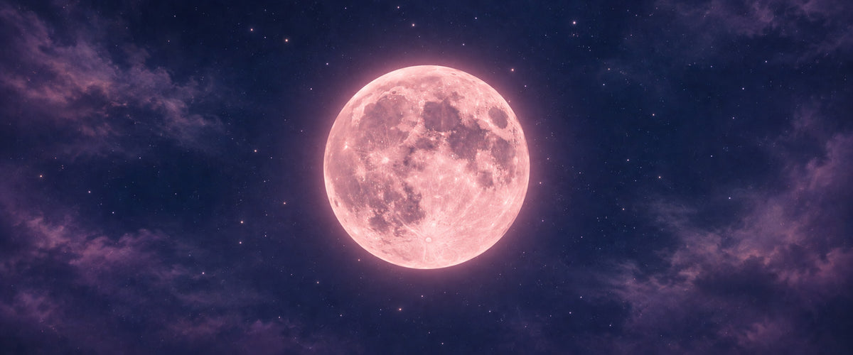 Glowing pink full moon surrounded by stars and soft purple clouds.