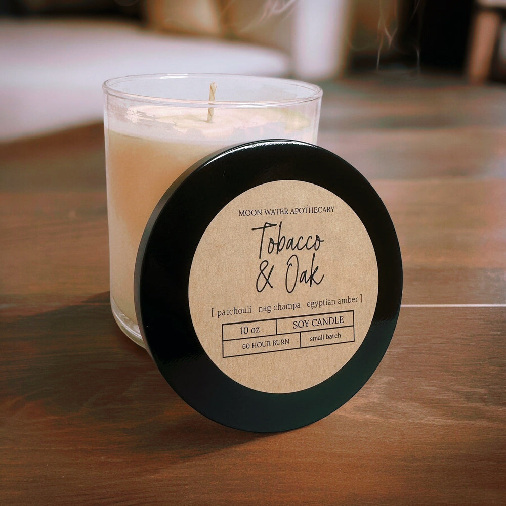 Candle with a label on a wooden surface