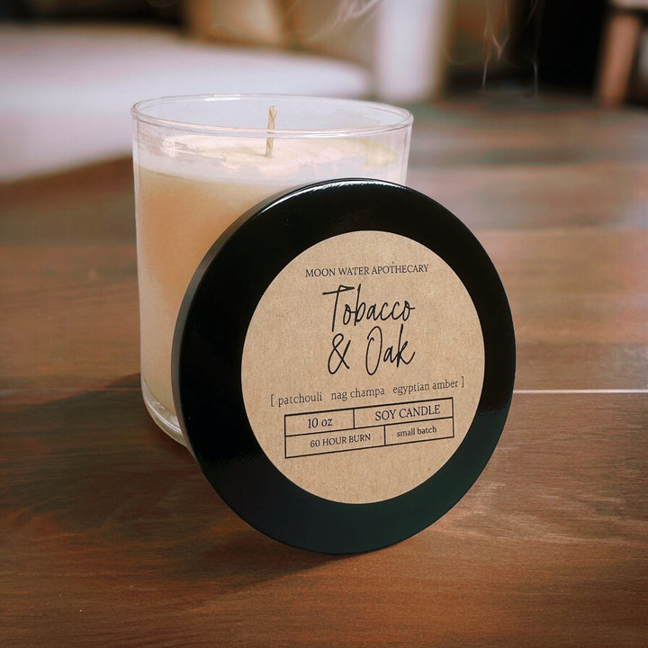 Candle with a label on a wooden surface