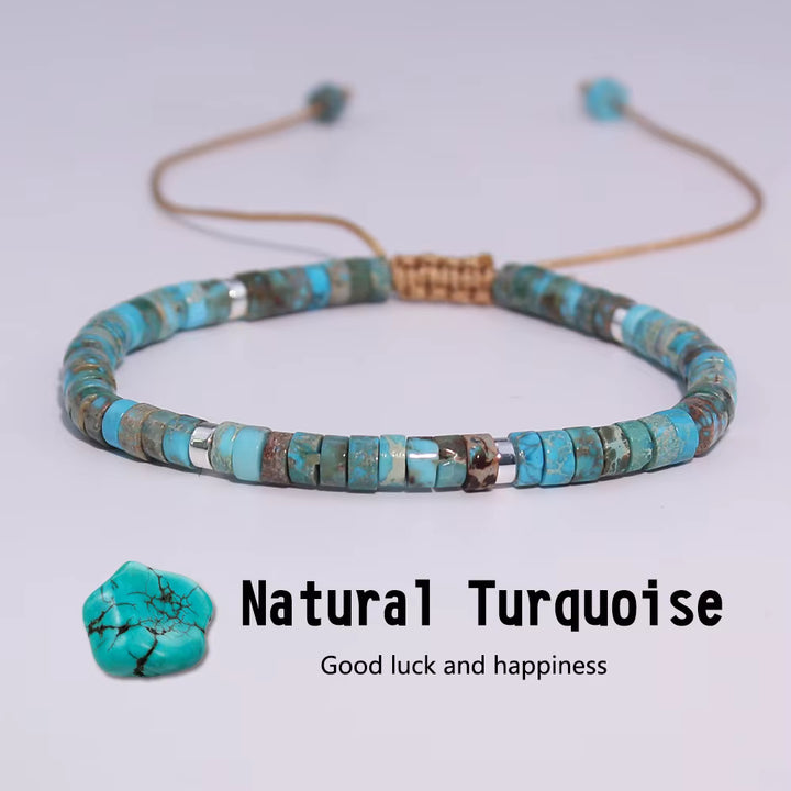 Turquoise beaded bracelet with a stone on a light gray background