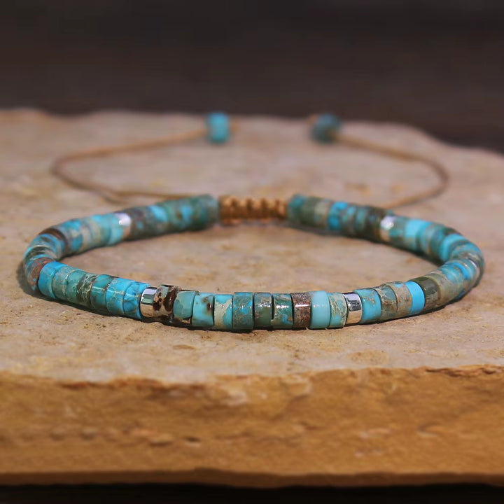 Turquoise beaded necklace on a wooden surface