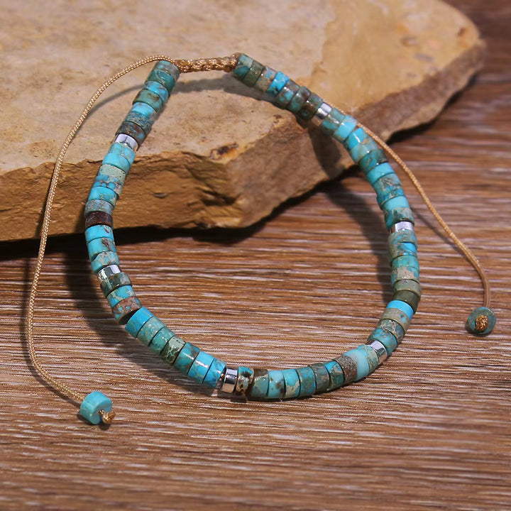 Turquoise beaded necklace on a wooden surface