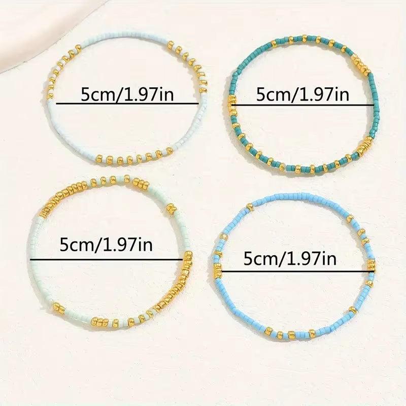 Four beaded stretch bracelets arranged in a 2x2 grid on a light cream background, each with a black measurement line and text reading 5cm/1.97in.
