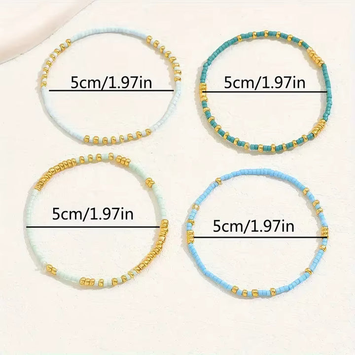 Four beaded stretch bracelets arranged in a 2x2 grid on a light cream background, each with a black measurement line and text reading 5cm/1.97in.